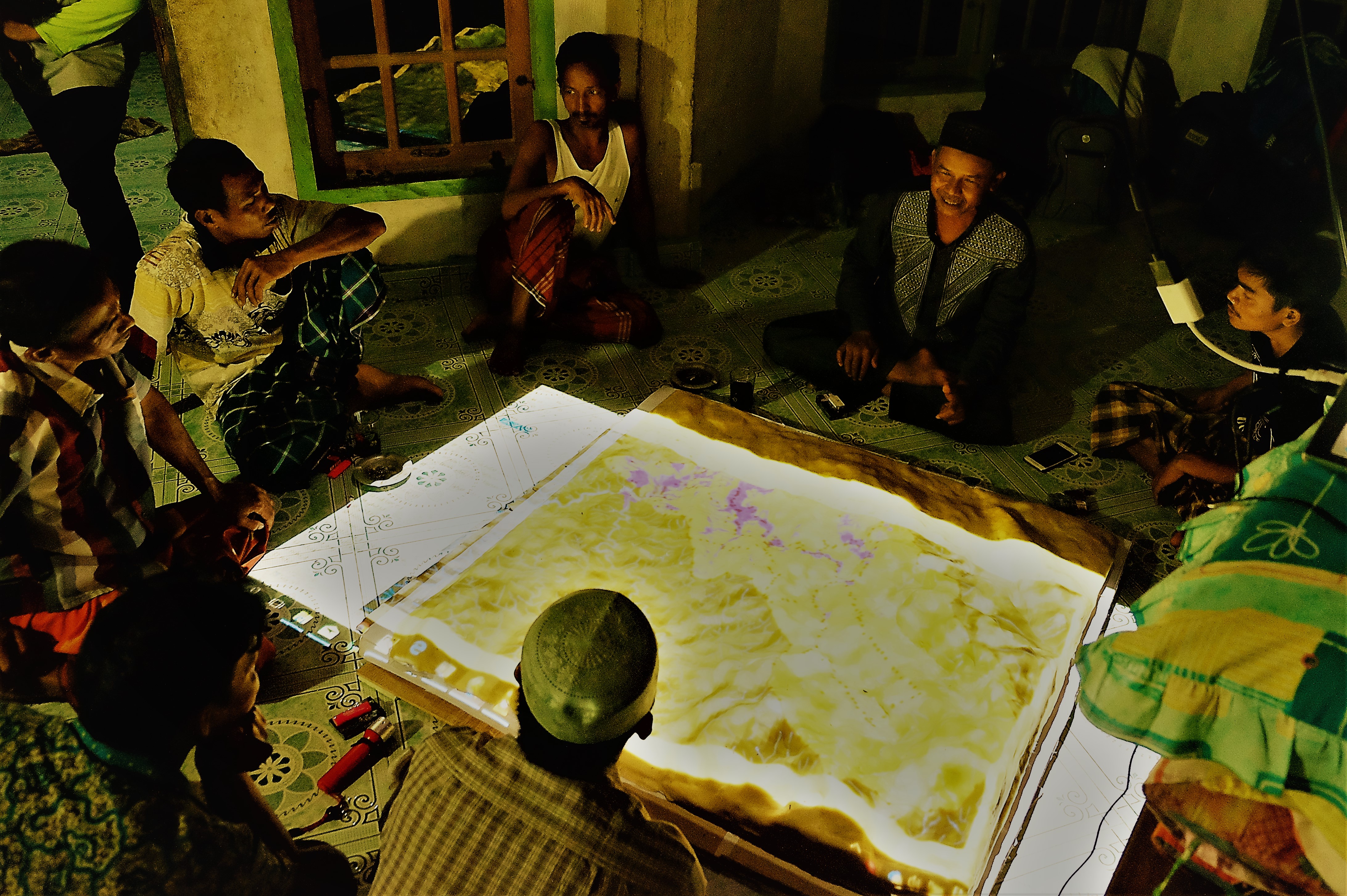 <p> Masyarakat adat di Gajah Bertalut, Kampar, Riau melihat hasil maket peta 3D di wilayah adat mereka Foto oleh Julius Lawalata.</p>